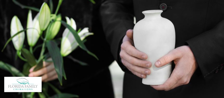 Man holding an urn after pre planning cremation services